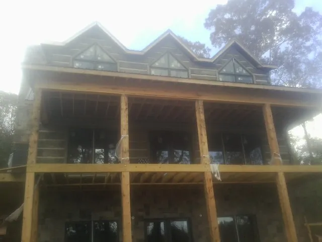 Dormers and porch framing on a large log home under construction in Julian