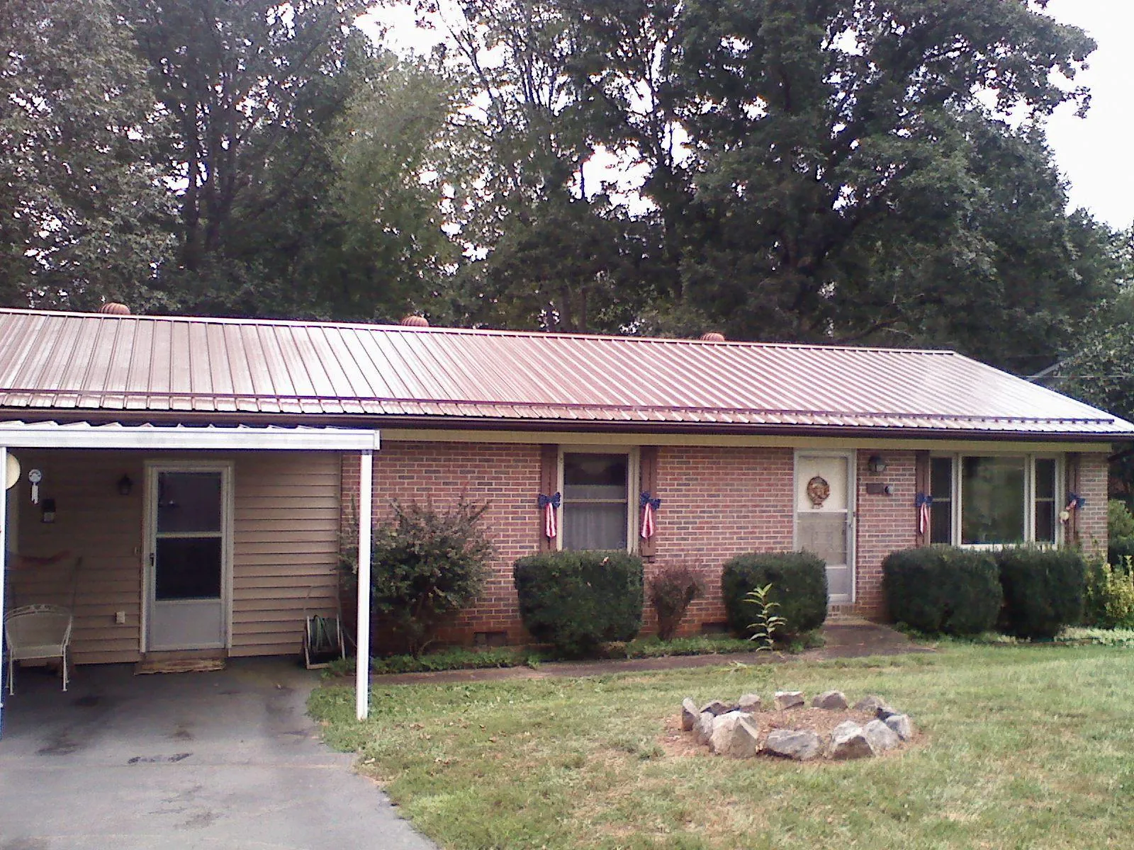 Bronze metal roof and carport on a brick ranch home — Roof Repair work by our crew in Julian